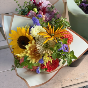 Mixed color bouquet with sunflowers, aster, dahlias, zinnias, and more